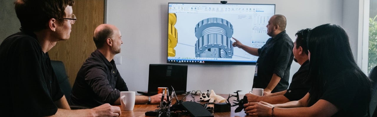 3D engineers looking at screen with 3D printed part_GoProto and RopesEdge 