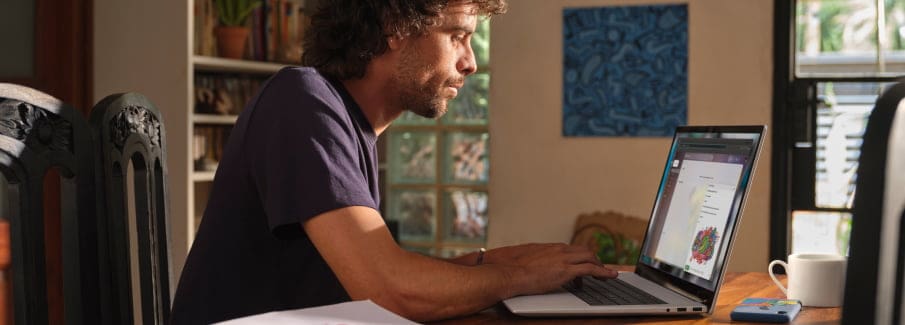 A person sitting at a desk wearing headphones and using their HP Pavilion