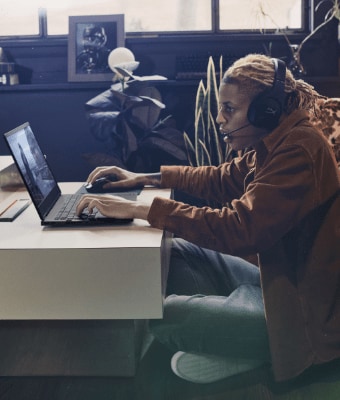 Man playing online, with headset and Omen laptop