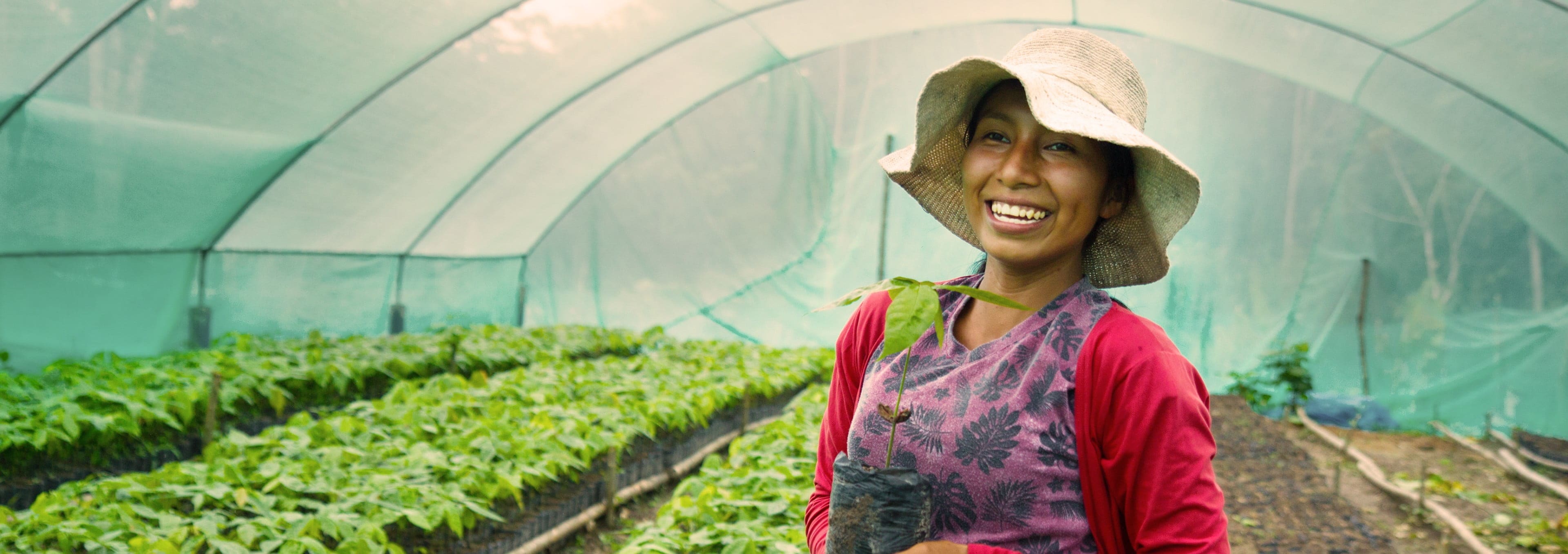 Lady wearing hat in greenhouse