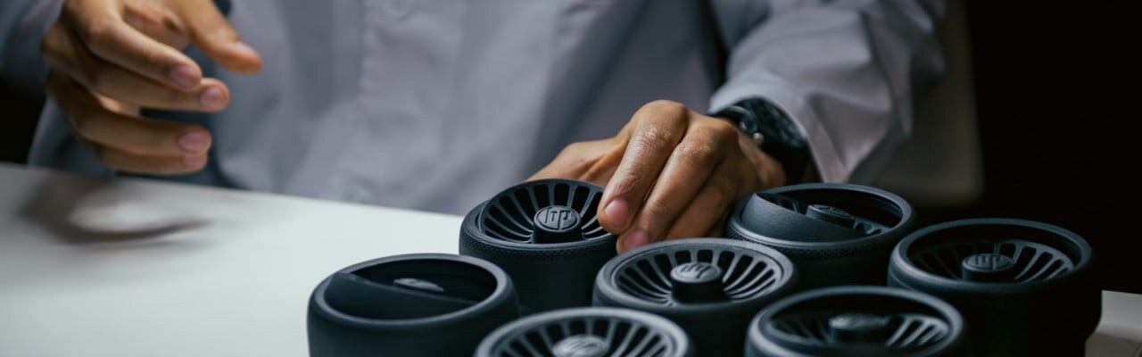 Few 3D printed parts of ventilation system lying on a table 