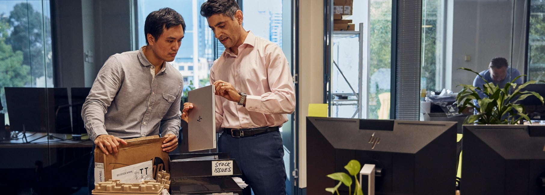 IT team examining HP laptop