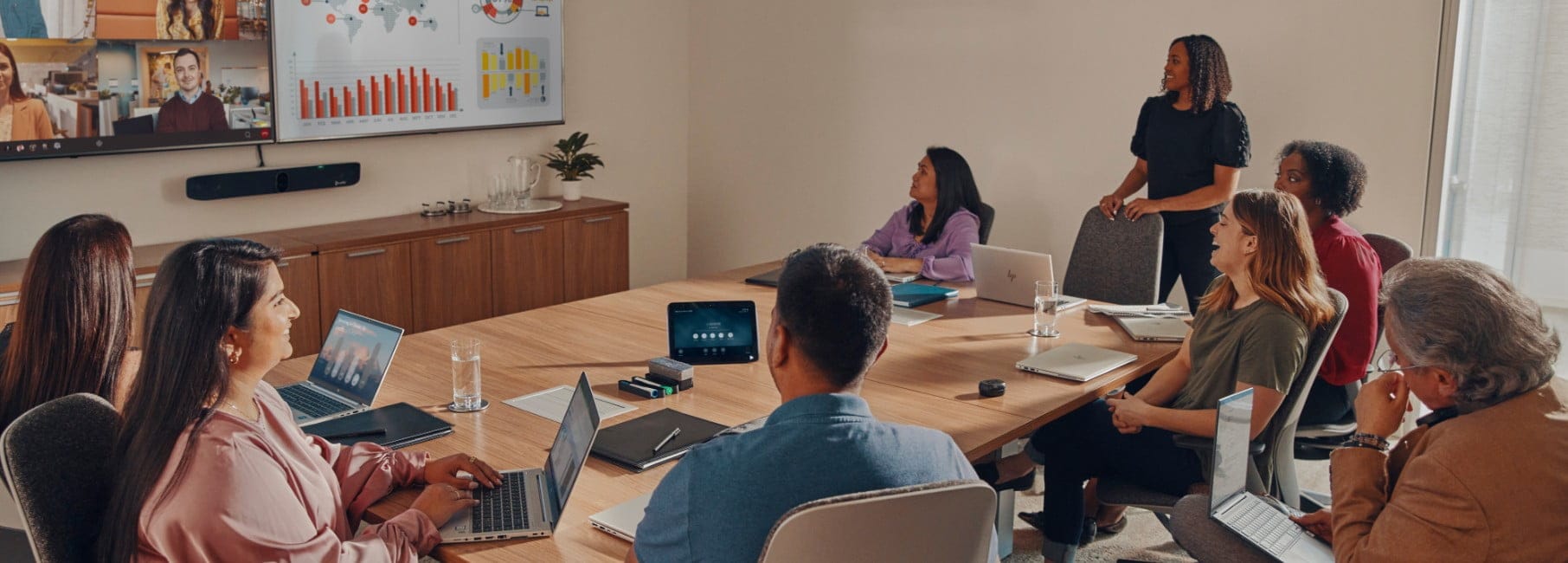 Employees in a meeting room on a video conference call