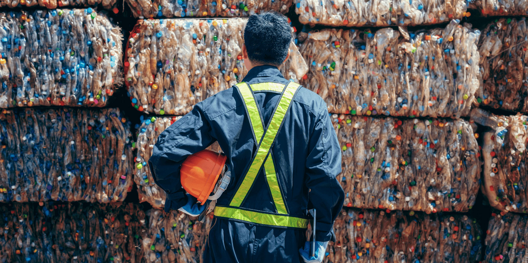 Person standing in front of recycling materials