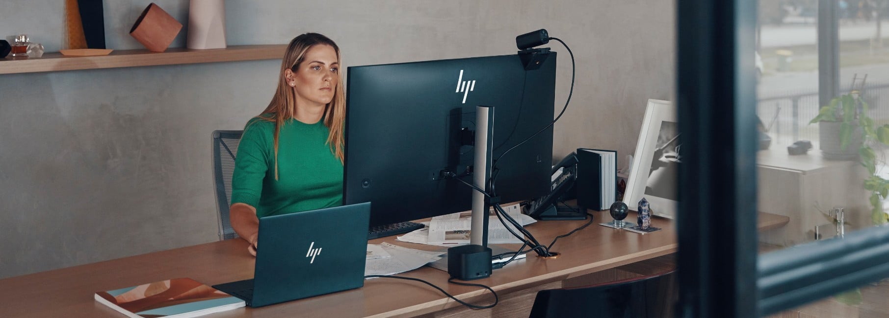 IT woman in office working at HP laptop