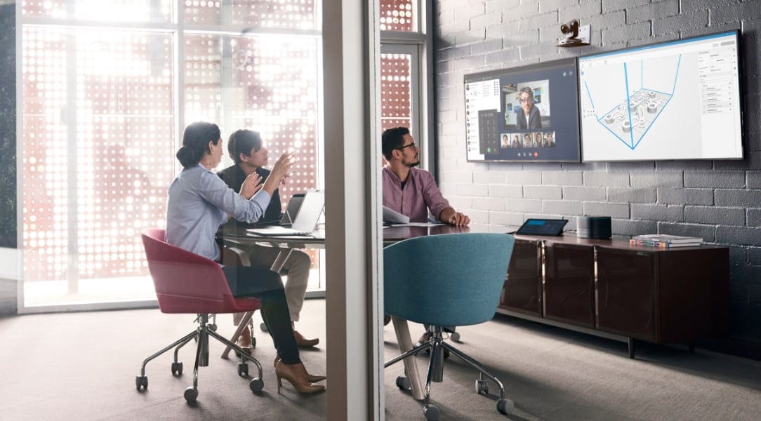 3D team in conference room looking at screen with 3D printed part 