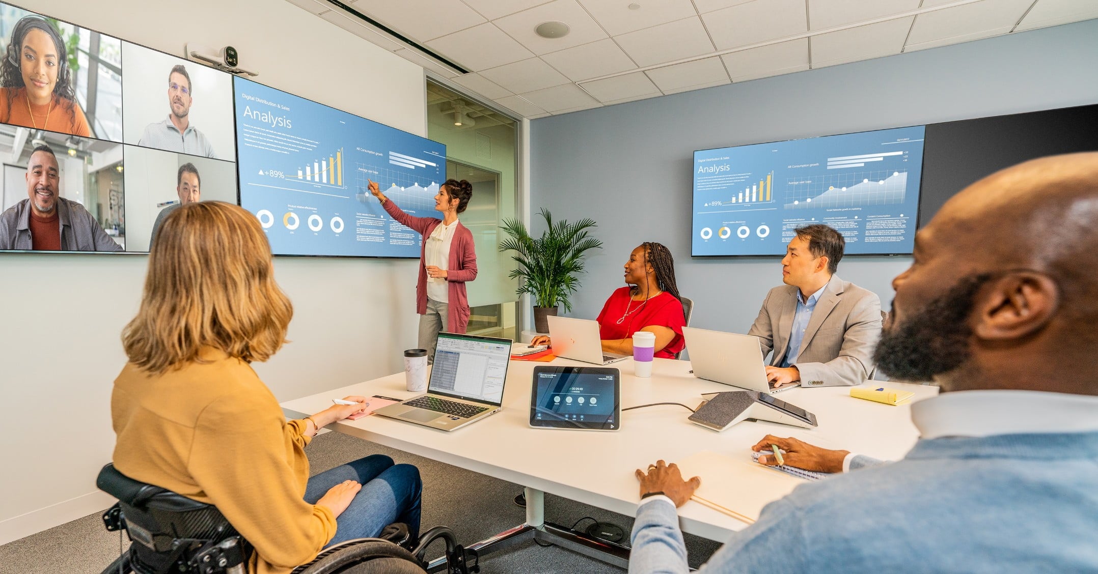 Group of people in a medium-sized conference room, engaged in a video call using the Poly G7500 all-in-one video bar