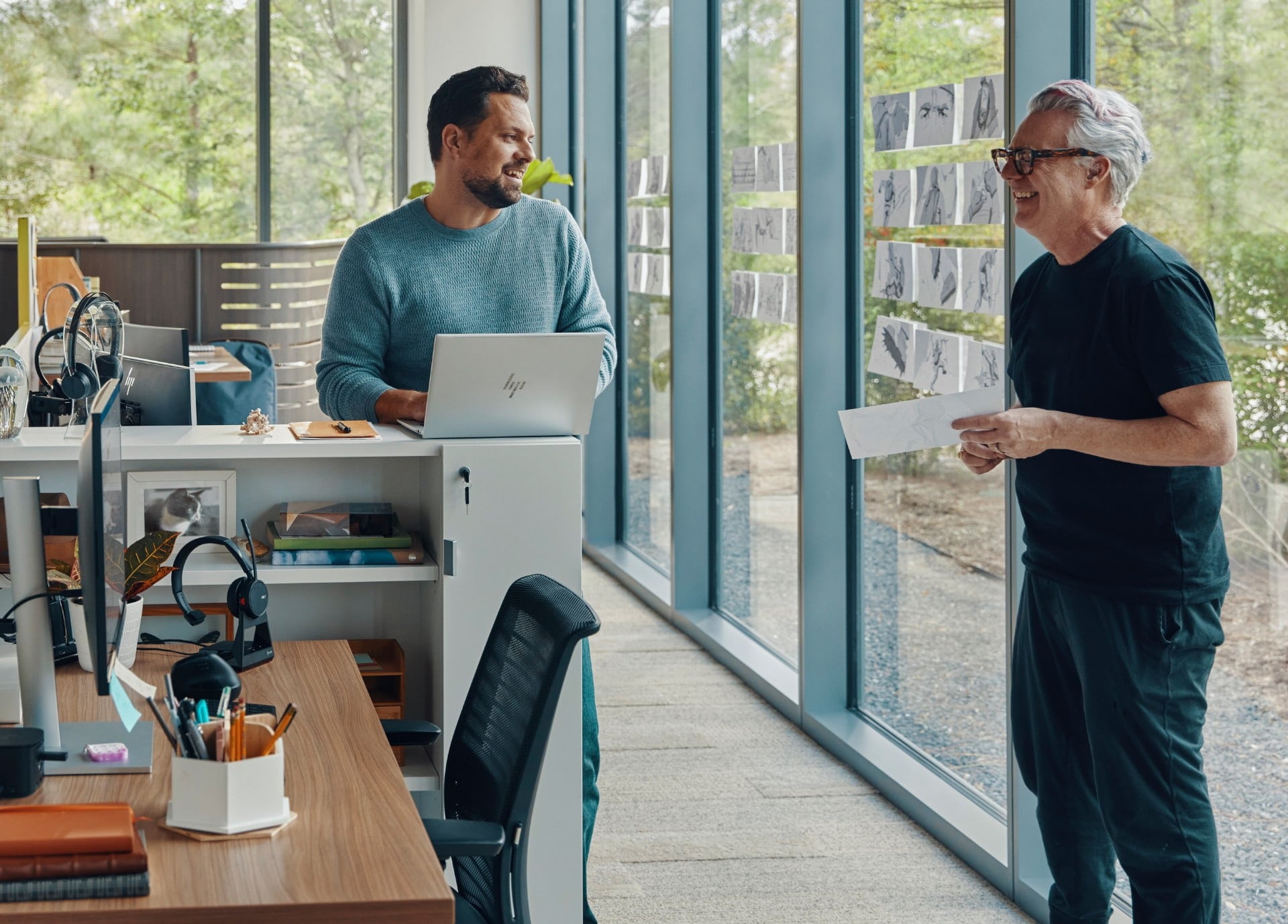 People collaborating in open office using HP laptop