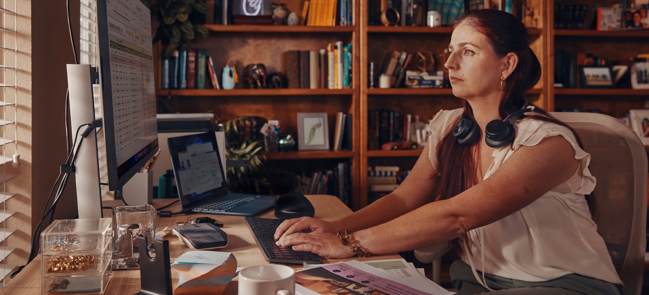 Poly Voyager Focus 2, Poly Sync 40, and other accessories in a home office