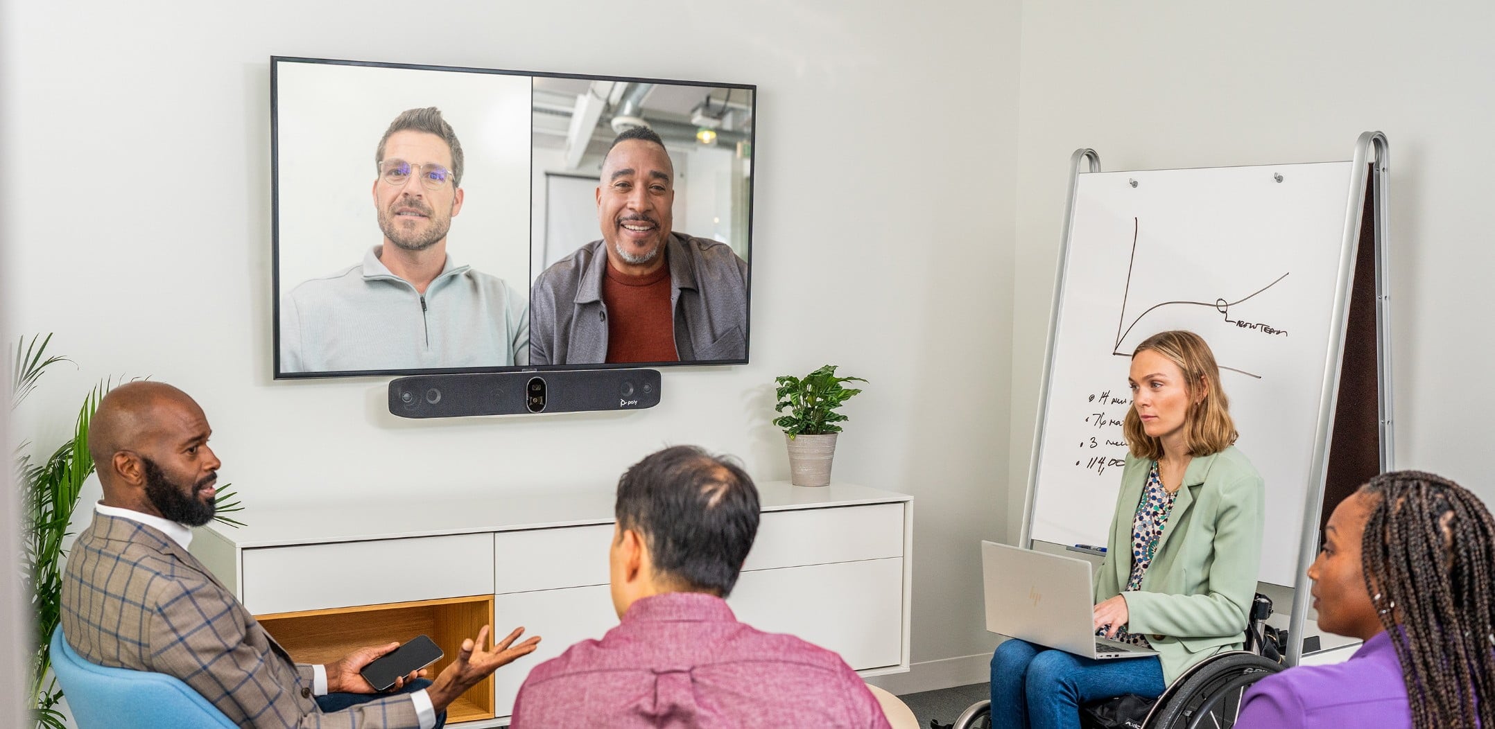 People in conference room during a video call using Poly Studio X70 video conferencing solution