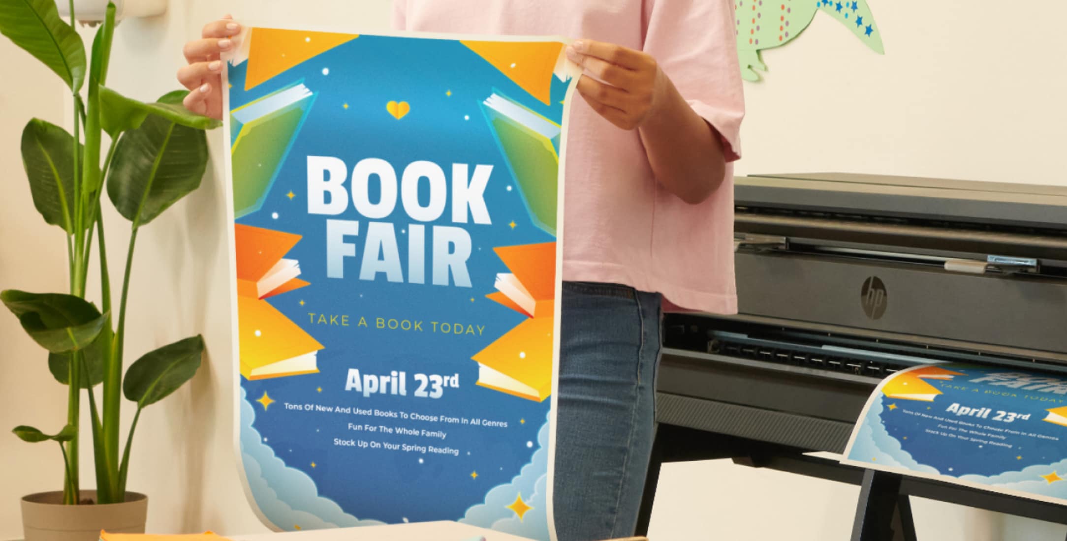 Woman holding printout of education poster printed on an HP DesignJet T850 printer