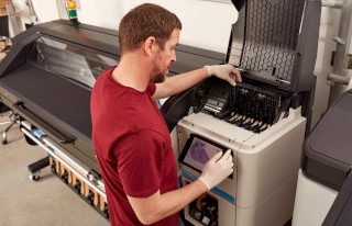 Man operating HP large format printer