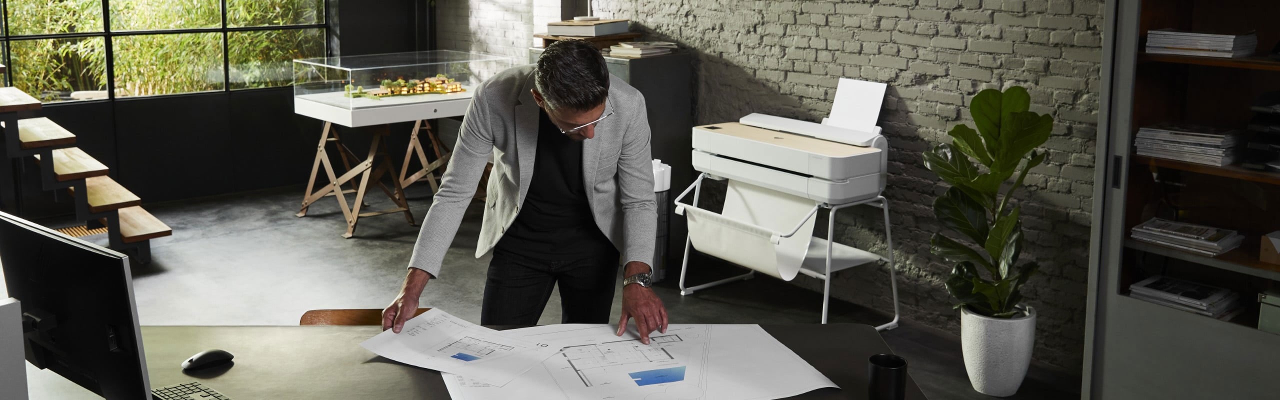 Man looking at blueprints on table