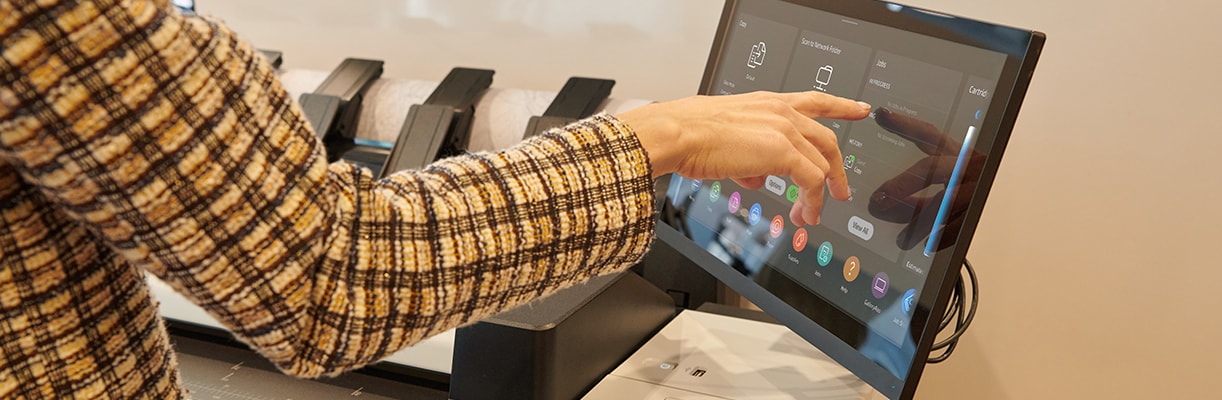 Person using the touchscreen of an HP large-format printer