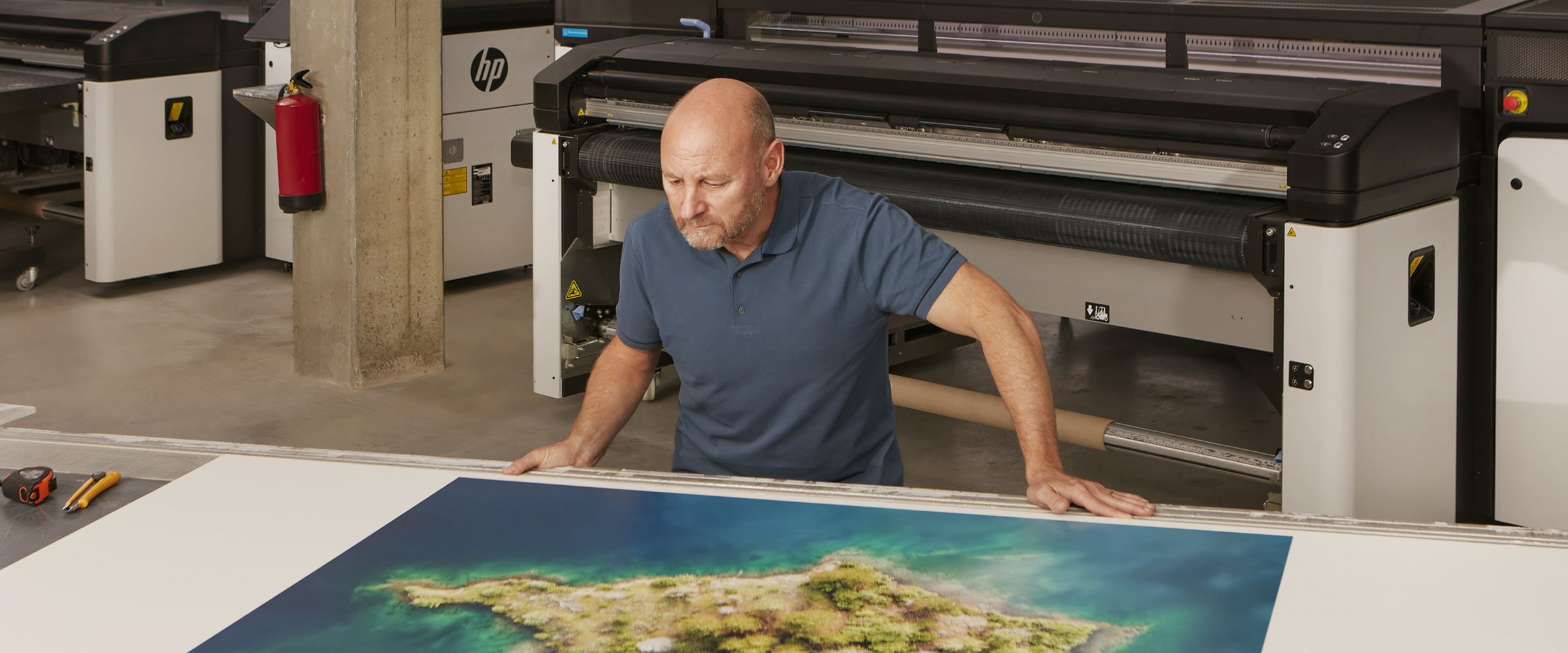 Man inspecting large color print