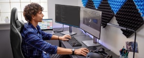 Male game developer works on code with HP Reverb G2 virtual realityheadset and controllers, HP 27K G3 4K USB-C Displays, and HP ZBookCreate 15 G7 Laptop.