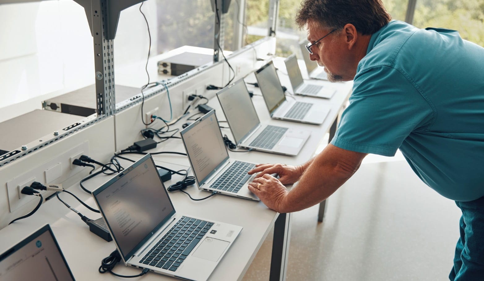 Man QA testing laptops