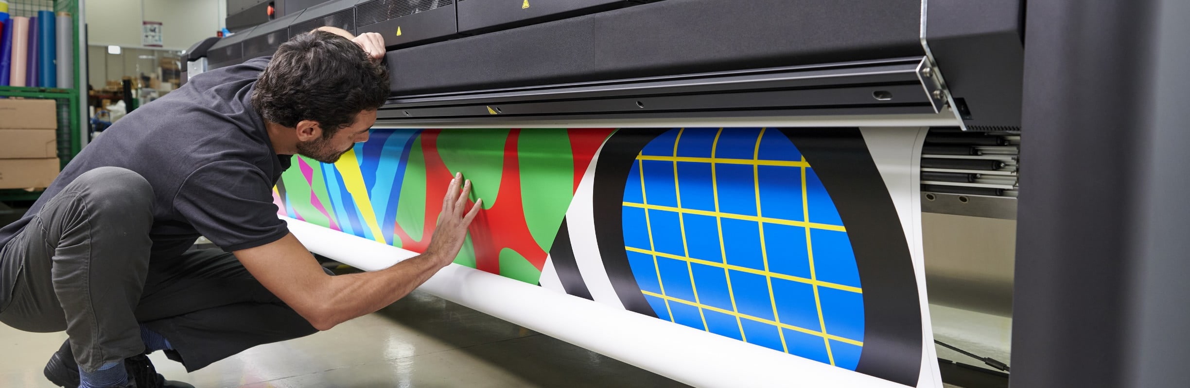 Man checking printed media in an HP Latex printer