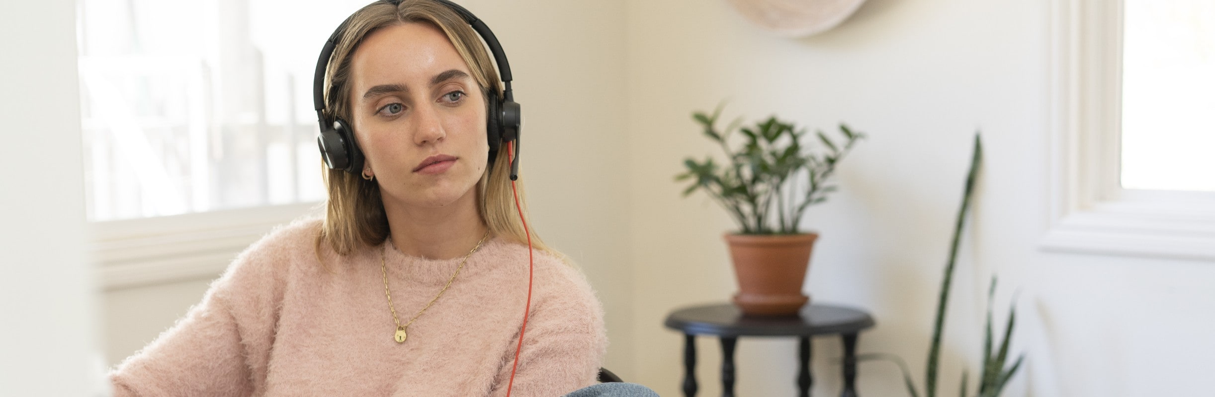 Woman working from home office, wearing Poly Blackwire 8225 USB wired headset