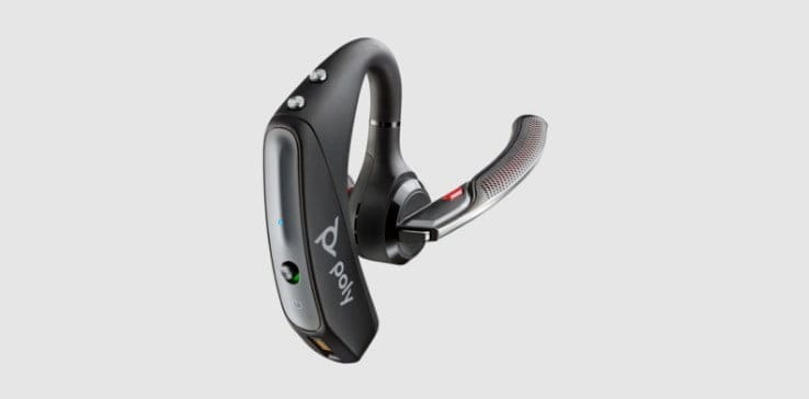 Poly Voyager 5200 Bluetooth mono headset with boom microphone rotated up and eartip pivoted inwards for transport or placement in charging case