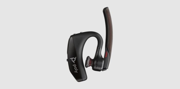 Poly Voyager 5200 Bluetooth mono headset with boom microphone rotated up and eartip pivoted inwards for transport or placement in charging case