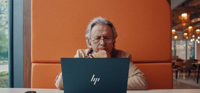 Man thinking while using HP laptop