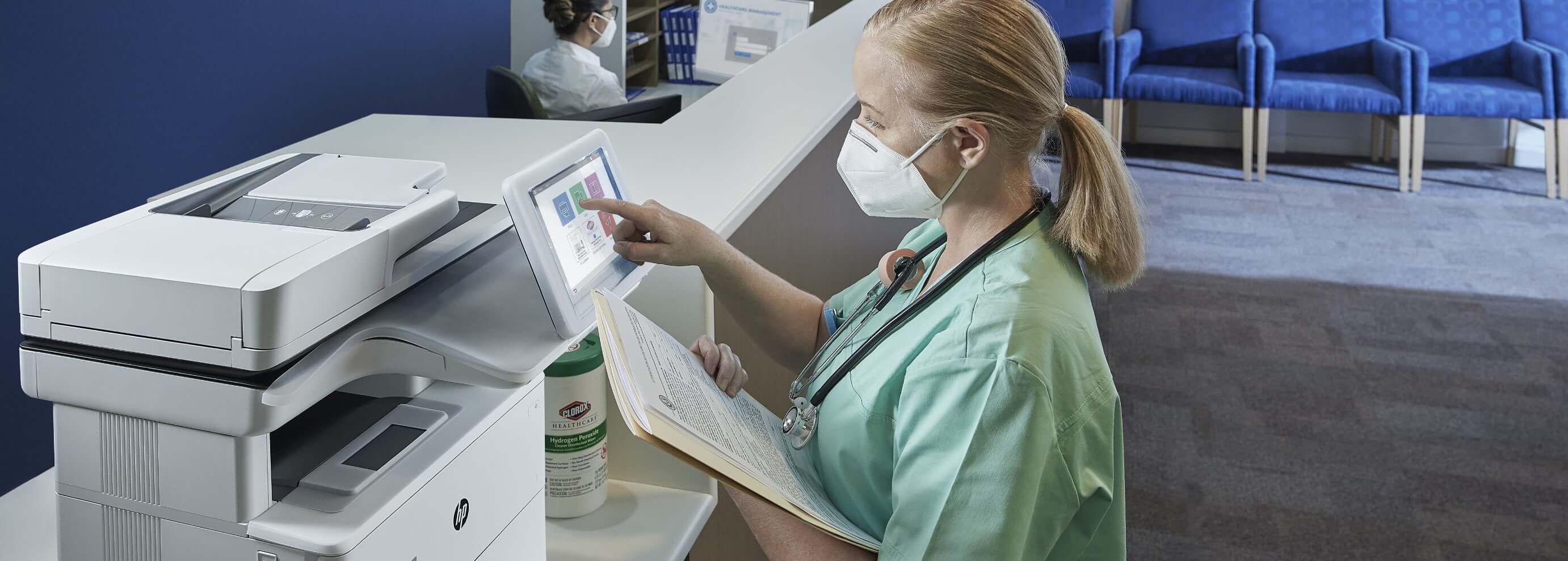 Nurse using an HP Healthcare Printer to digitize documents.