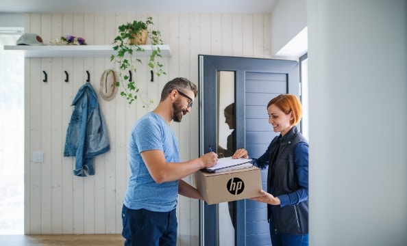 A man receiving an HP package from a delivery woman.