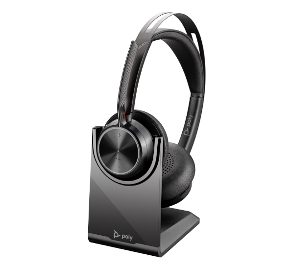 Poly Voyager Focus 2 USB headset on desktop charging stand
